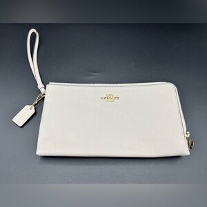 Coach Cream Wristlet Clutch. With two zipper pockets and credit card slots.
